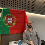 Flag of Portugal with man standing behind